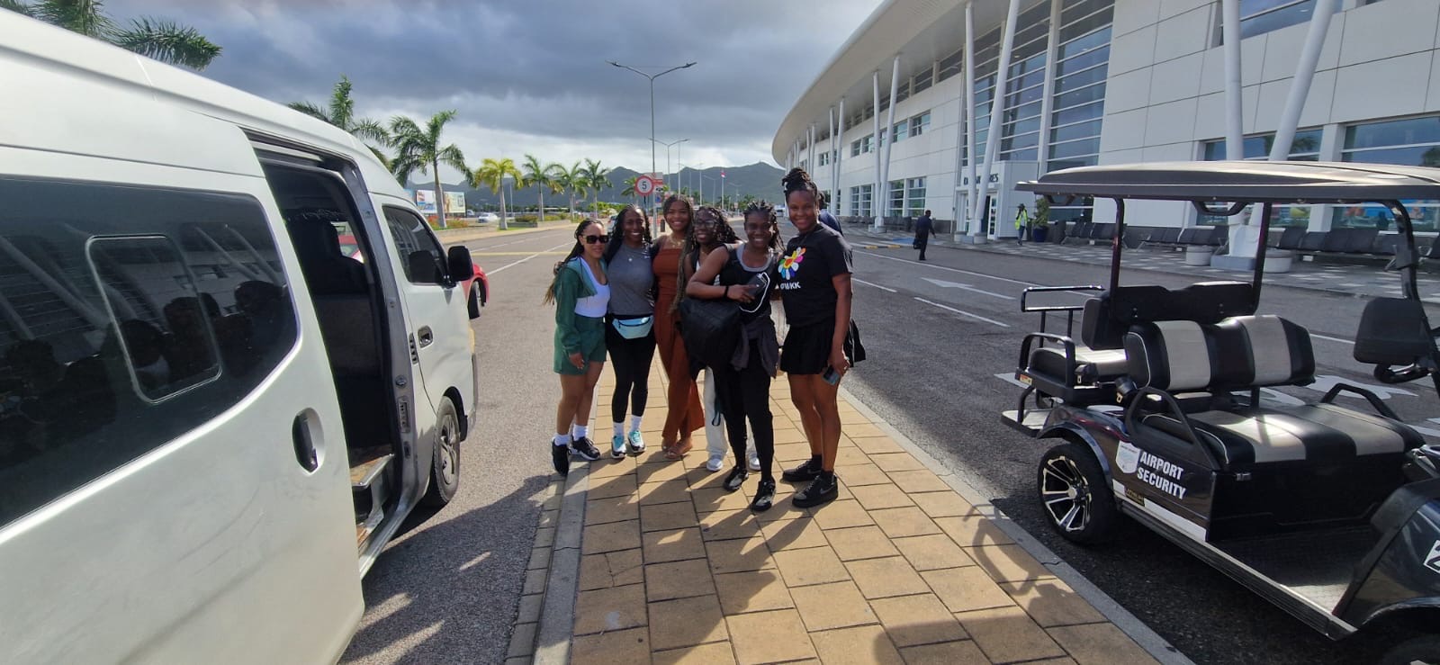 Girls' trip met right outside the terminal, van door already open.